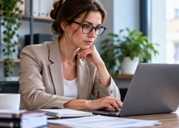 Polish entrepreneur working at a laptop in a small office