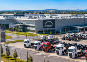 Modern truck manufacturing plant in Poland with rows of heavy trucks outside