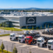 Modern truck manufacturing plant in Poland with rows of heavy trucks outside