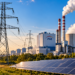 AI-generated conceptual scene combining fictional PGE-branded power plant, electricity transmission towers and solar panels; not a photograph of an actual PGE facility
