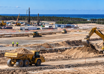 Large coastal construction site with earthworks and heavy machinery at Poland’s planned first nuclear power plant location