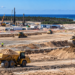 Large coastal construction site with earthworks and heavy machinery at Poland’s planned first nuclear power plant location