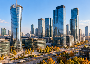 AI-generated cityscape representing Warsaw's business district with modern office towers and trams; conceptual image, not a documentary photograph of Berkshire Hathaway Specialty Insurance's office